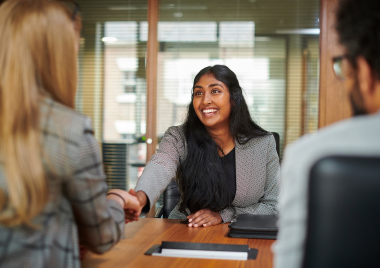 woman shaking employers hand