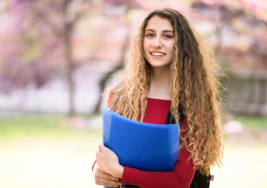 teenage girl holding books