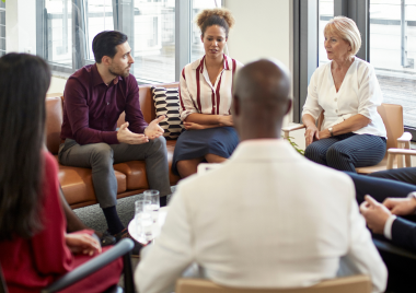 Group of people in a circle having a discussion