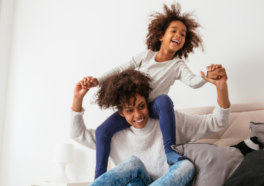 Adult holding child on their shoulders