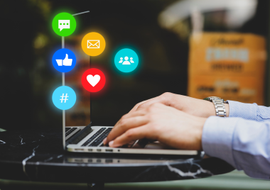 Person typing on a laptop with graphics