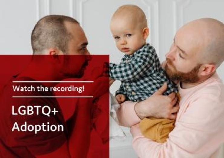 two men holding a baby