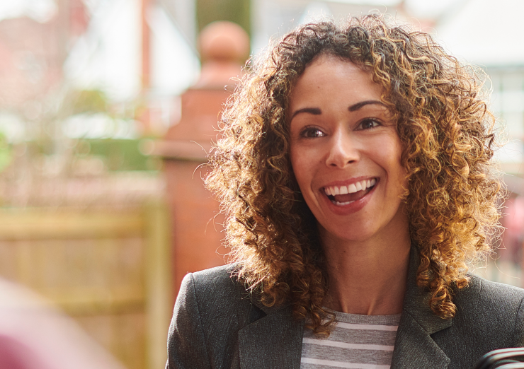 woman with curly hair smiling